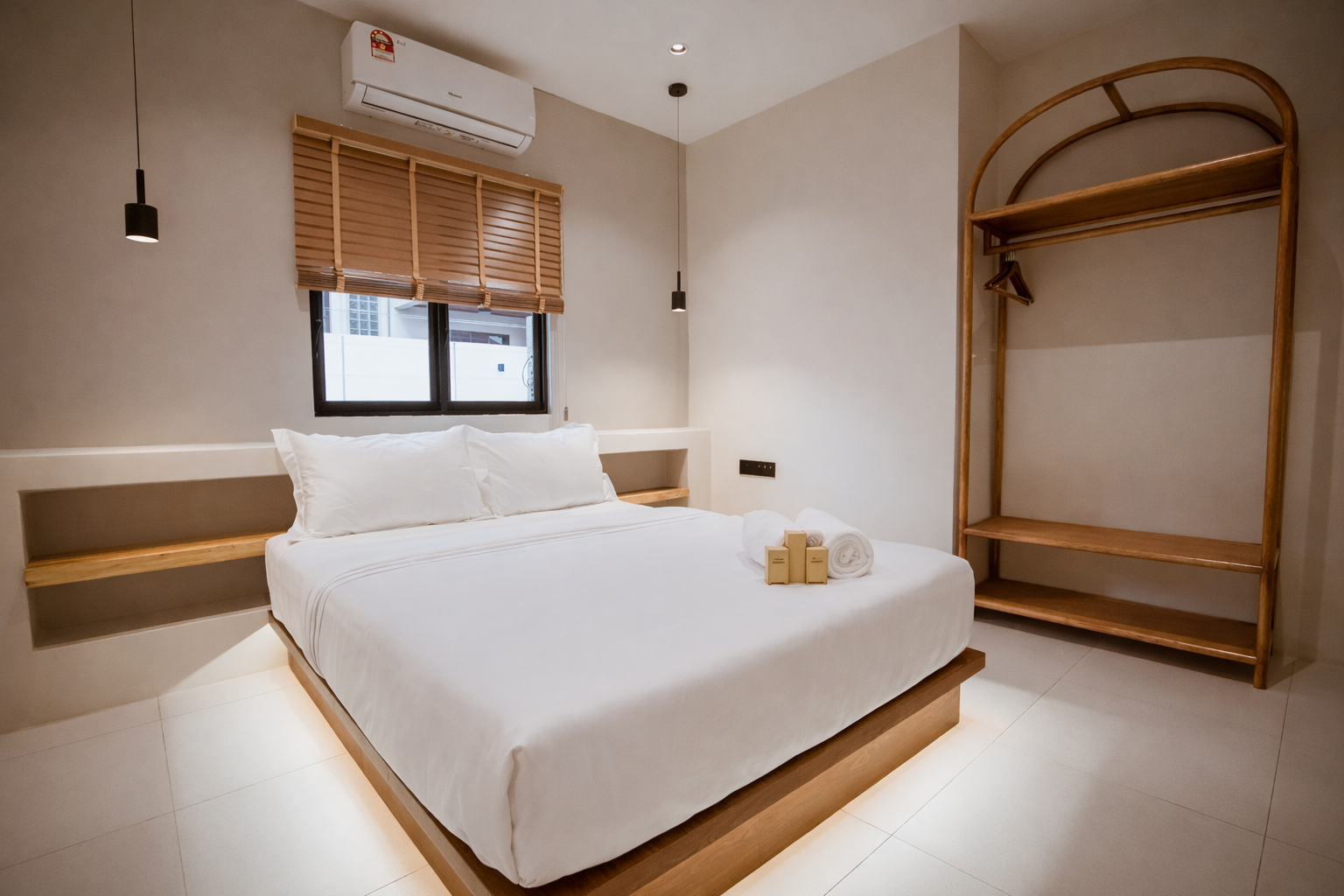 A queen bed with an open wardrobe.